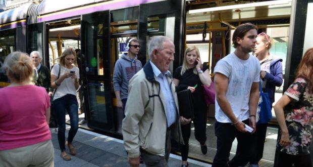 Customers using the Luas yesterday on the 10th anniversary of its launch, alight at the St Stephen’s Green Luas stop in Dublin. Photograph: Dara Mac Dónaill/ The Irish Times