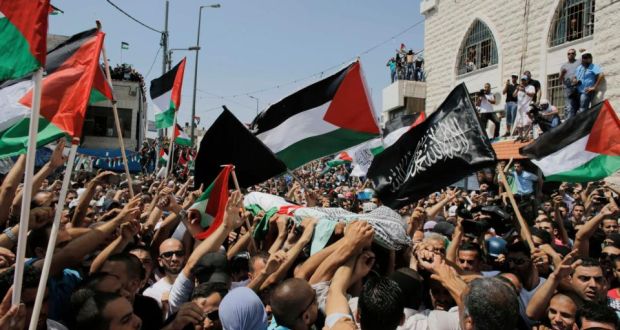 Palestinians carry the body of Mohammed Abu Khudair, the 16-year-old who was kidnapped and killed on Tuesday, during his funeral in an Arab suburb of Jerusalem yesterday.   Photograph: Ammar Awad/Reuters  