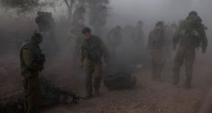 Israeli soldiers prepare themselves across from the Gaza Strip today. Photograph: Baz Ratner/Reuters 