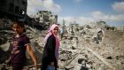 Palestinians inspect destroyed houses in the Shejaia neighbourhood, which witnesses said was heavily hit by Israeli shelling and air strikes during an Israeli offensive, in Gaza City today. Photograph: Reuters 