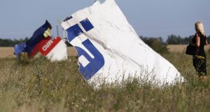 A woman takes a photograph of wreckage at the crash site of Malaysia Airlines Flight MH17 near the village of Hrabove (Grabovo), Donetsk region. Photograph: Reuters 