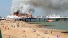Fire and smoke engulf part of the pier in Eastbourne today. Photograph: Reuters
