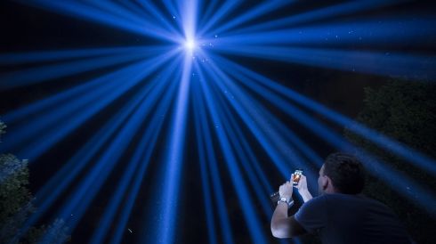A man photographs the Spectra installation by Japanese artist Ryoji Ikeda, commemorating the centenary of Britain's involvement in the first World War in London on August 4th, 2014.  Photograph: Oli Scarff/Getty Images
