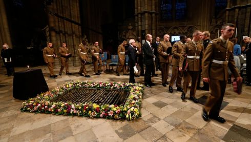 Servicemen walk by the Grave of the Unknown Warrior as they arrive for a candlelit vigil and prayer service to commemorate the centenary of the outbreak of the first World War at Westminster Abbey, London.  Photograph: Sang Tan/WPA Pool/Getty Images
