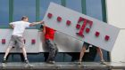 A T-Mobile logo being positioned on a shop front. Shares in Deutsche Telekom fell as much as 5 per cent to a 16-week low on Wednesday. Photograph: Kacper Pempel/Reuters