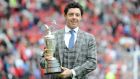 Rory McIlroy holds the British Open Claret Jug trophy on the Old Trafford pitch during half-time of Manchester United’s   Premier League match against Swansea City at Old Trafford. Photograph: Martin Rickett/PA Wire