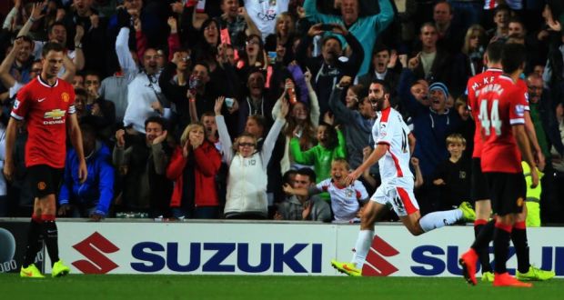 Millton Keynes Dons striker Will Grigg celebrates his second goal against Manchester United during the Capital One Cup second round match at Stadium:mk, Milton Keynes. Photograph: Nick Potts/PA Wire. 