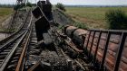 Train wagons are seen on the destroyed railway bridge which collapsed during the fighting between the Ukrainian army and pro-Russian separatists, over a main road leading to the eastern Ukrainian city of Donetsk. Photograph: Reuters 