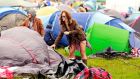 A festival-goer erects her tent on the first day of the Electric Picnic. Photograph: Reuters 
