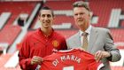  Manchester United winger Angel Di Maria  displays his new shirt and number on the pitch at Old Trafford with Manchester United manager Louis van Gaal. Photo: Peter Powell/EPA  