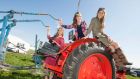 Models on a 1967 Nuffield tractor at Ratheniska, Co Laois. The 2014 National Ploughing Championships will be held there this month. Photograph: Alf Harvey 