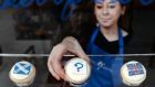 A bakery employee places a ‘question mark’ cupcake between a Scottish Saltire cake and a Union cupcake at a bakery in Edinburgh yesterday. Photograph: EPA/Andy Rain