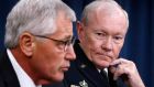 Chairman of the Joint Chiefs of Staff Gen. Martin Dempsey (right) listens to US secretary of defense Chuck Hagel (left) talk in a press briefing at the Pentagon in Washington last night. Photograph: Reuters 