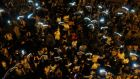 Protesters wave mobile phones as they sing during a rally blocking the main road to the financial central district in Hong Kong. Photograph: Bobby Yip/Reuters