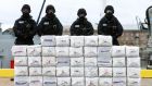 Members of the Irish navy standing behind what is believed to be around a tonne of cocaine seized from the yacht Makayabella, in an international operation involving the Irish Navy and the NCA. Photograph: Brian Lawless/PA Wire 