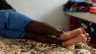 At rest: A young asylum seeker at the Green School emergency acccommodation centre in Augusta, Sicily. Photograph: Frank Miller