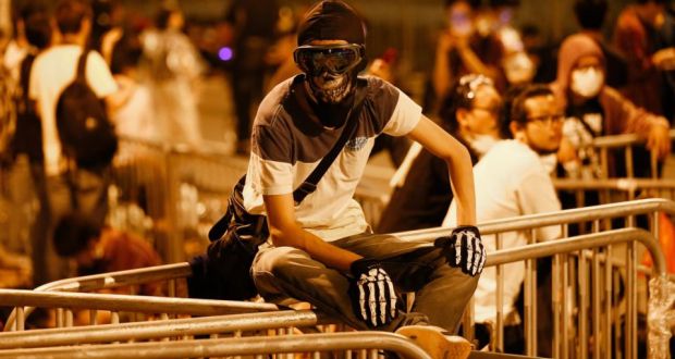  A pro-democracy protester from the Occupy Central movement retreats to a barricade area after police dispersed protesters along a tunnel road in the  Admiralty District of Hong Kong today. Photograph: EPA