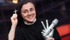 Italian sister Cristina Scuccia holding her prize after winning the The Voice of Italy in Milan in June. Photograph: Matteo Bazzi/EPA