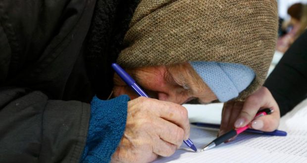 An elderly woman signs documents before receiving a ballot during a parliamentary election at a polling station in the eastern Ukrainian town of Slaviansk today. Photograph: Reuters