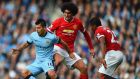   Sergio Agüero of Manchester City is closed down by Marouane Fellaini (centre) and  Antonio Valencia of Manchester United   at Etihad Stadium on Sunday. Photograph:  Laurence Griffiths/Getty Images