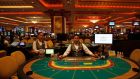 Croupiers sit in front of gaming tables inside a casino in Macau. October is set to be the worst month on record for casino revenues in the world’s biggest gambling hub Macau. Photograph: REUTERS/Tyrone Siu