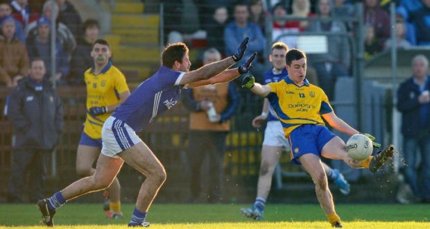 The Nire’s Conor Gleeson fields the ball with John Galvin of Cratloe attempting tyo block. Photograph: Ken Sutton/Inpho