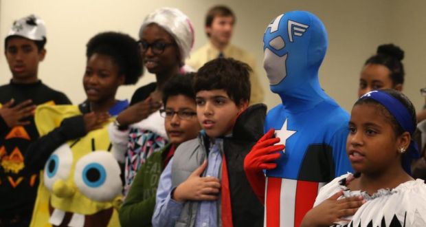 Children from 21 countries wear Halloween costumes as they recite the Pledge of Allegiance after becoming American citizens during a naturaliSation ceremony in Baltimore, Maryland on October 31st. Photograph: Mark Wilson/Getty Images