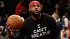 Cleveland Cavaliers forward LeBron James is seen wearing a ‘I CAN’T BREATHE’ tee-shirt while he warms up before game time against the Brooklyn Nets during their NBA game at Barclays Center in Brooklyn, New York, USA, 08 December 2014. Photograph: Jason Szenes/EPA