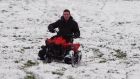 Darryle McClurkin on a quad bike in a snow covered field in the Belfast hills on Friday. Photograph: Niall Carson/PA Wire 