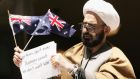 A file picture of Iranian muslim cleric Man Haron Monis bound in chains and holding an Australian flag after being charged with seven counts of unlawfully using the postal service to menace in 2009. Photograph: EPA