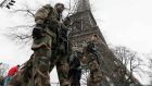 French soldiers patrol near the Eiffel Tower in Paris as part of the ‘Vigipirate’ security plan. Photograoh: Gonzalo Fuentes/Reuters