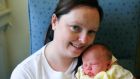 Jennifer Bourke from Artane in Dublin pictured with her new baby boy, Kian who was born at 4 seconds past midnight in the Rotunda Hospital, Dublin. Photograph: Aidan Crawley