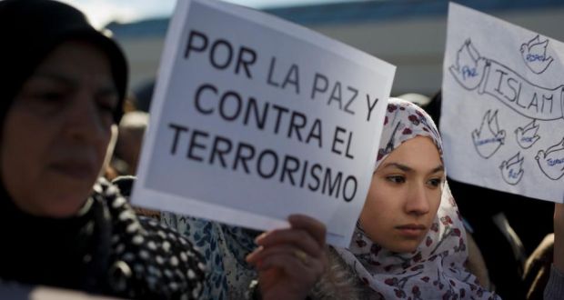 A Muslim protester holds a placard reading “Islam” and another one holds one reading “For peace and against terrorism” during a demonstration outside Atocha Station in Madrid against the recent Paris Charlie Hebdo attacks . Photograph: Pablo Blazquez Dominguez/Getty Images