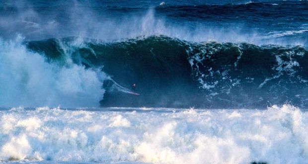 Professional surfer Andrew Cotton rides a large wave at Mullaghmore, Co Sligo. Photograph: Finn Mullen