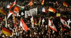 Members of the anti-islamist group PEGIDA hold flags during a demonstration in Dresden on Monday. Photograph: Fabrizio Bensch/Reuters. 