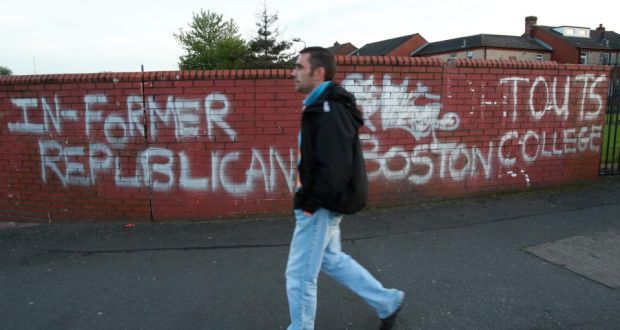 A man walks past graffiti relating to the Boston College tapes on the Falls Road, west Belfast last year.  Photograph: Paul McErlane/EPA