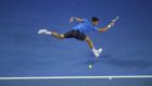 Novak Djokovic stretches to hit a backhand return during his match against    Gilles Muller  at  the Australian Open in  Melbourne. Photograph:  Lukas Coch/EPA 