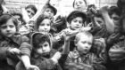 Some of the 600 children, who  survived Auschwitz II-Birkenau, show their tattooed identification numbers. Some 7,000 prisoners, including more than 600 children and youths below the age of 18, were alive when the camp was liberated. Photograph: Reuters
