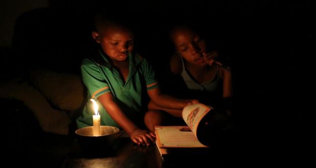 Studying by candle light during load shedding in Soweto.  Photograph: Siphiwe Sibeko/Reuters