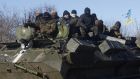 Ukrainian servicemen ride on top of an armoured personnel carrier on the way from Artemivsk to Debaltseve. Photograph: Anatoli Stepanolli/AFP