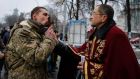  A man  in military uniform kisses a cross presented to him by a Ukrainian Orthodox priest after a commemoration ceremony for Maidan activists or ‘Heroes of the Heavenly Hundred’, who were killed on the Maidan during anti-government protests in Kiev last year. Photograph: Roman Pilipey/EPA.