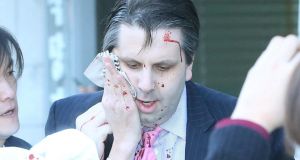 US ambassador to South Korea Mark Lippert  covers a wound to his face as he leaves the Sejong Cultural Institute after he was injured in an attack by an armed assailant. Photograph: Yonhap/AFP/Getty Images
