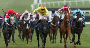 Aux Ptits Soins ridden by Sam Twiston-Davies (yellow) wins the Coral Cup ahead of Zabana. Photograph:  Alex Livesey/Getty Images