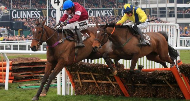 Milsean ridden by jockey Danny Mullins (left) leads from eventual winner Martello Tower ridden by Adrian Heskin during the Albert Bartlett Novices’ Hurdle on Gold Cup Day   at Cheltenham. Photograph: Nick Potts/PA 