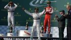 Lewis Hamilton celebrates on the podium following his Melbourne Grand Prix victory. Photograph: Afp