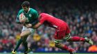 Jared Payne of Ireland is tackled by Taulupe Faletau of Wales during the  Six Nations match at the  Millennium Stadium  in Cardiff. Photograph: Dan Mullan/Getty Images
