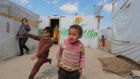 Children playing at a makeshift settlement for Syrian refugees in Bar Elias, in the Bekaa valley. The Britain-based Syrian Observatory for Human Rights said more than 215,000 people have been killed since the start of the crisis in 2011, about  half of them civilians. Photograph: Jamal Saidi/Reuters 