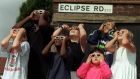 Children from the Eclipse Road area of London view the solar eclipse in 1999. Photograph:  Fiona Hanson/PA Wire 