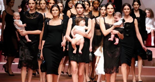 ‘Pregnant models stalked down the catwalk, and instead of carrying dinky little handbags, some of the models toted beautiful babies.’  Photograph: REUTERS/Alessandro Bianchi