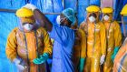 One year has passed since the declaration of what became the largest Ebola outbreak in history, with more than 10,000 deaths and 24,000 people infected. But health experts and charities have warned the danger is far from over. Picture show healthcare workers prepare to go inside of the high-risk area for the first time, at the Hastings Ebola treatment unit in Freetown, Sierra Leone, in November. Photograph: Daniel Berehulak/The New York Times.